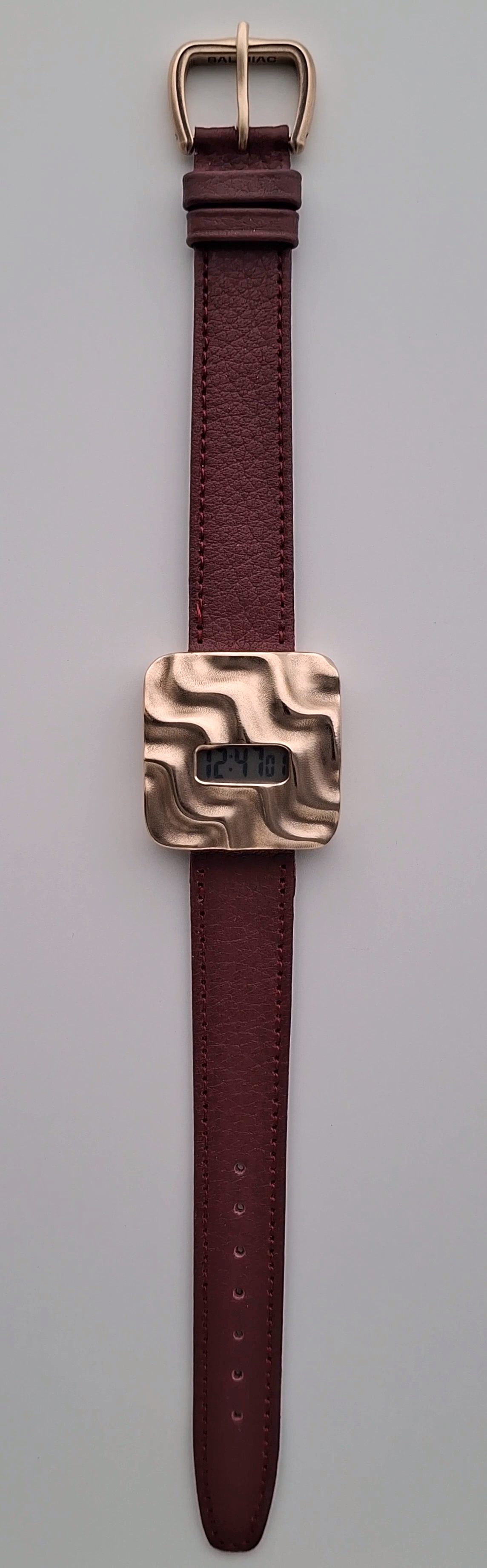 The complete Askja prototype with its bronze buckle and dark red leather strap